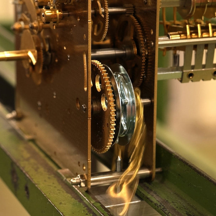 Close-up of mechanical clock movement chain and gears