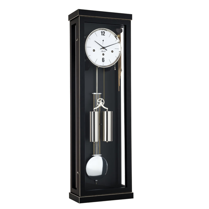 Black wall clock with dual weights and pendulum on a white background