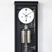 Close up black wall clock with white face and Hermle logo