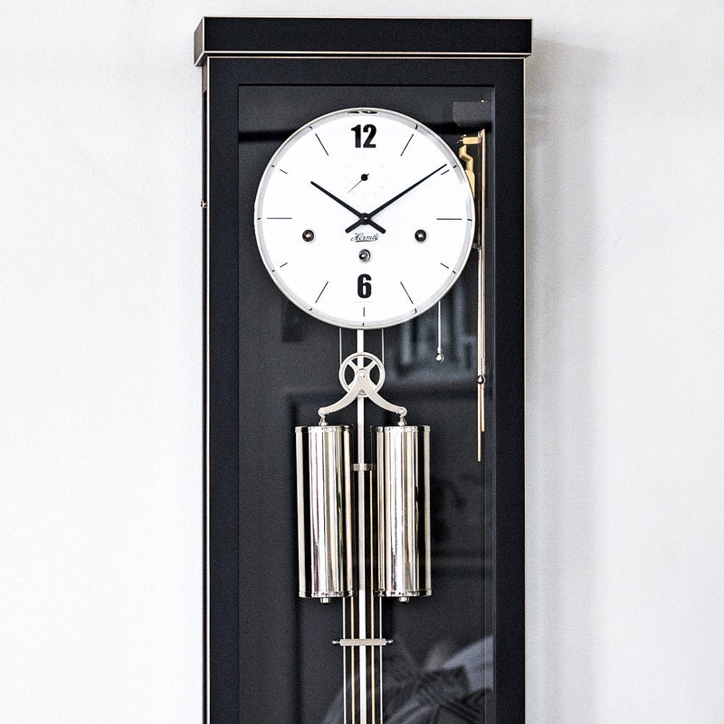 Close up black wall clock with white face and Hermle logo