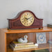 Wooden mantel clock on a shelf with books and decorative items.