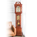 Cherry wood Grandmother clock with brass highlights in white room