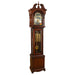 Cherry wood Grandmother clock with brass highlights on white background.