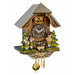 A traditional German cuckoo clock shaped like a mountain chalet with a gray shingled roof, carved wooden figures of German Oompah band, green and yellow pine trees, and brass hanging weights below.