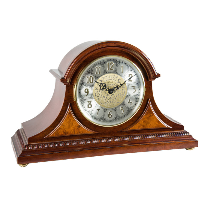 Cherry wood mantle clock with detailed face on white background