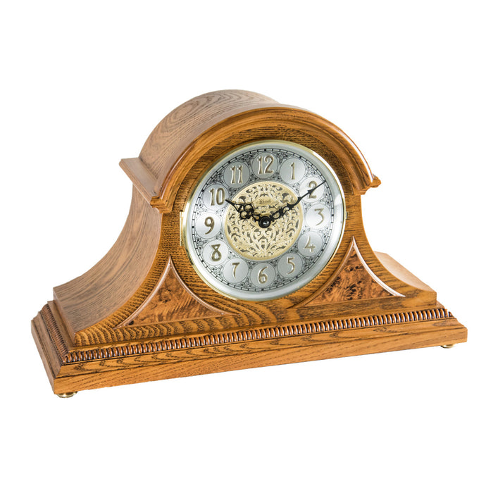 Light oak wood mantle clock with detailed face on white background