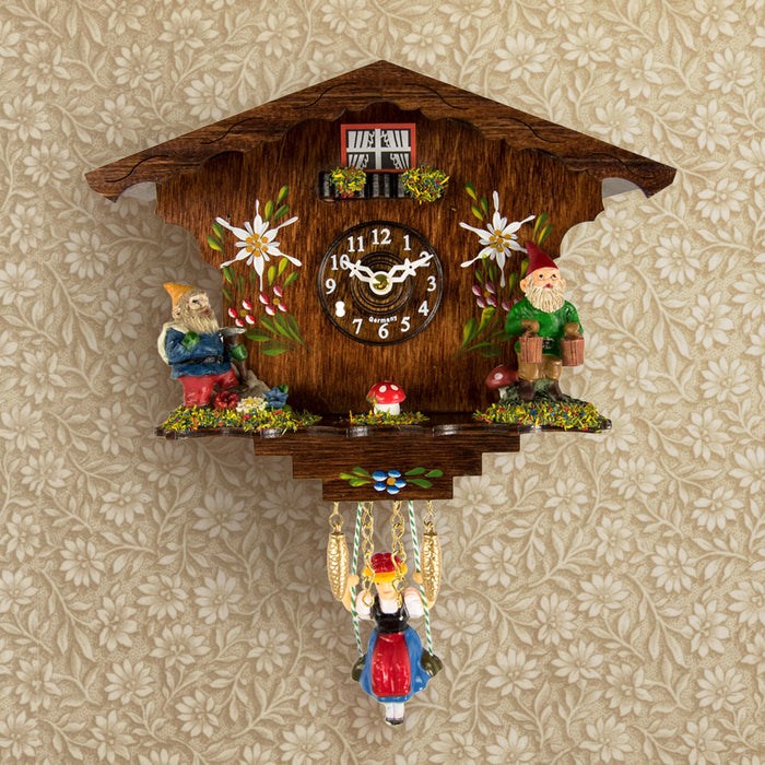 Wooden vintage style cuckoo clock with gnomes and girl on swing 
