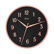 Wall clock with rose gold highlights and black face with Arabic numerals on white background.