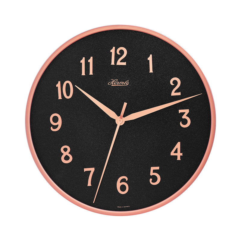Wall clock with rose gold highlights and black face with Arabic numerals on white background.