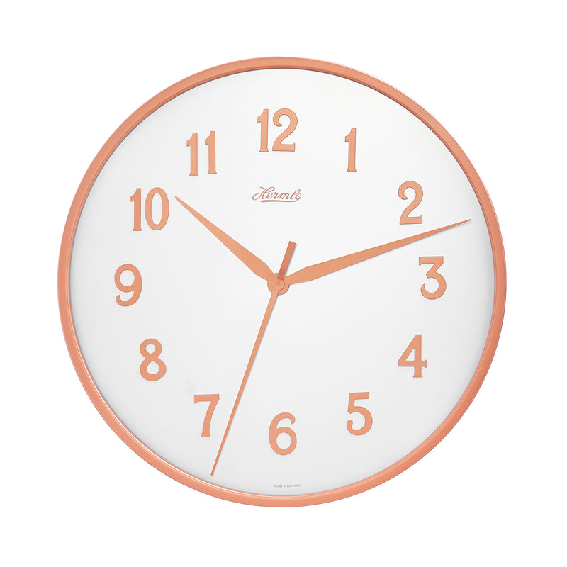 Wall clock with white face and gold numbers on white background.