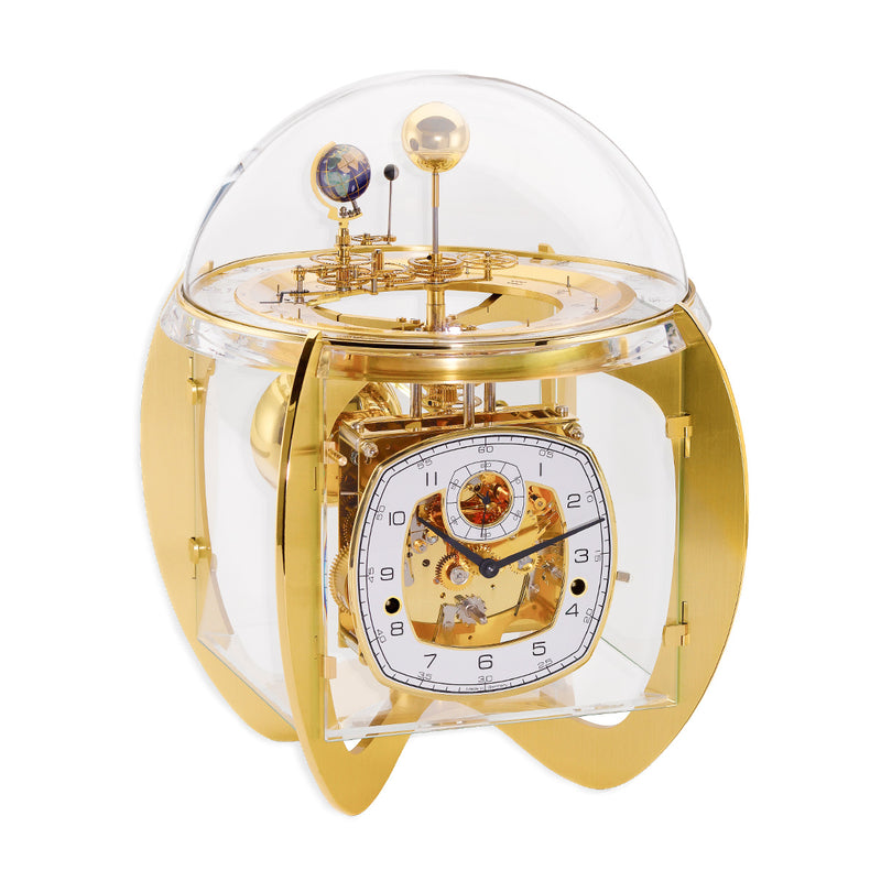 Gold astronomical clock with visible intricate movement and planet gears beneath glass dome on white background.