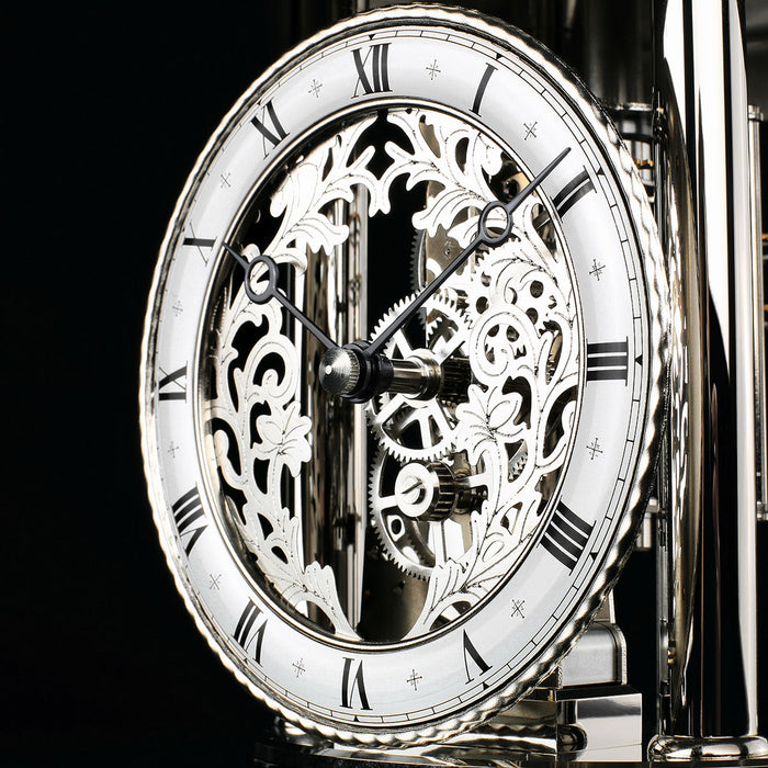 Skeleton clock face with finely crafted gears visible behind the hands
