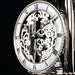 Skeleton clock face with finely crafted gears visible behind the hands