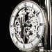 Skeleton clock face with finely crafted gears visible behind the hands