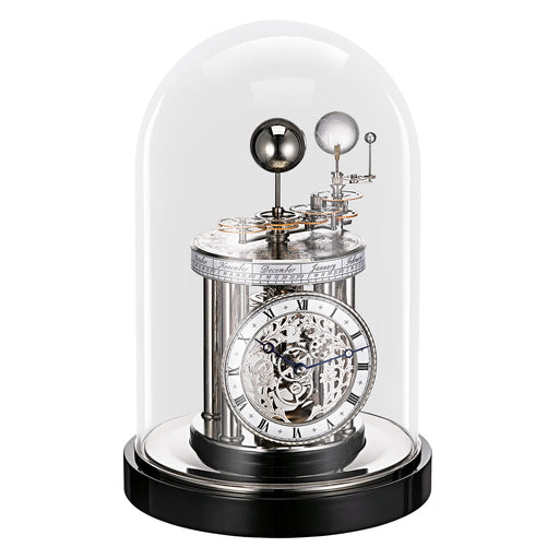 Decorative black clock with mechanical components under a glass dome on a white background