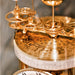 Close-up of a brass mechanical clock with intricate gears and star patterns.