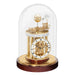 Decorative mahogany clock with mechanical components under a glass dome on a white background