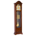 Walnut Grandfather clock with brass face and weights on white background
