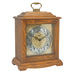 Dark Oak wood decorative clock with intricate design on a white background