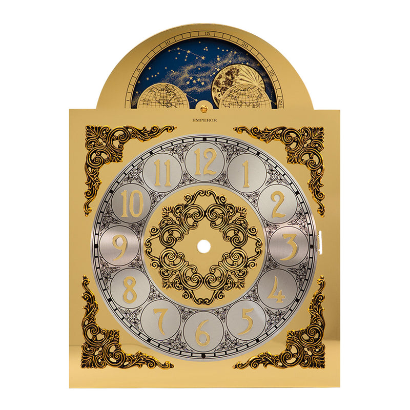 Brass clock face with intricate detail and moon dial with reflective finish on white background.
