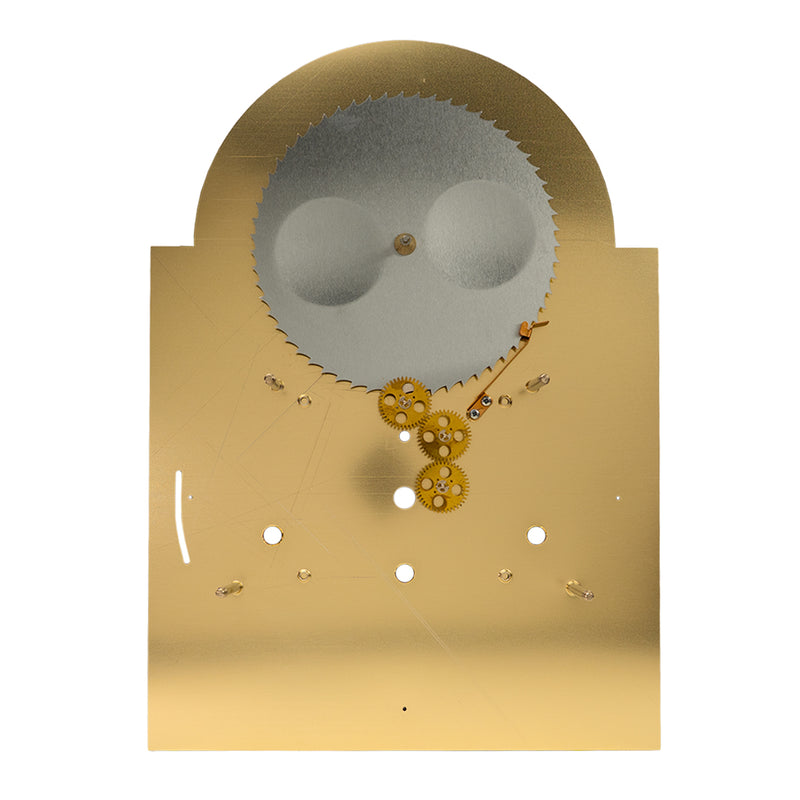 Back view of brass clock face with gearing visible on white background.