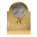 Back view of brass clock face with gearing visible on white background.