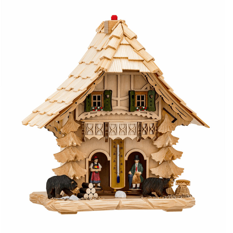 Light wood cuckoo-styled weather station with green shutters and bear figurines on white background.