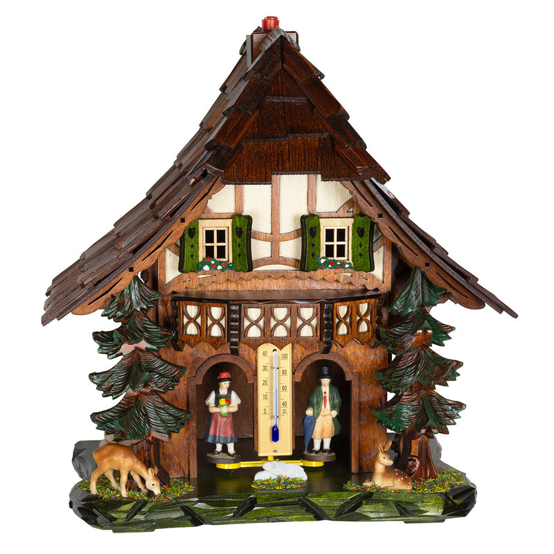 Dark wood cuckoo-style weather station with carved pine trees and deer figurines on white background.