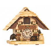 Ornate wooden cuckoo clock with bear figures in front of roman numeral clock face on white background.