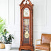 Cherry wood grandfather clock in white room with a green plants and leather chair.