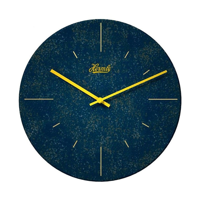 Dark blue wall clock with yellow hands and Hermle logo on what background.