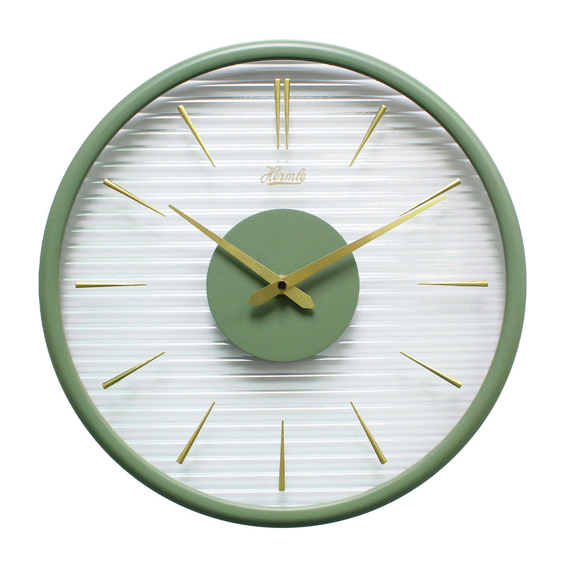Green wall clock with gold numeral markings and hands with clear ridged plastic face on white background.