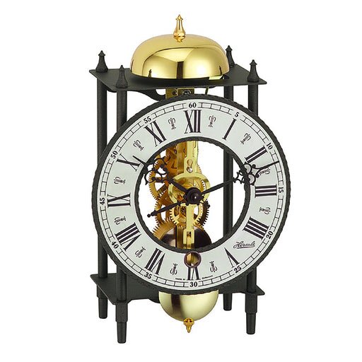 Mantel skeleton clock with visible brass gears and bell on white background.
