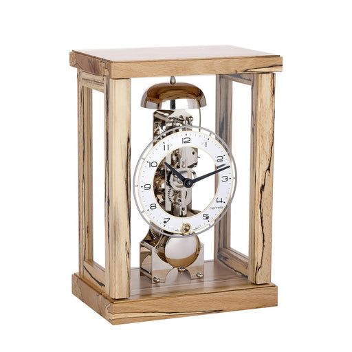 Light wooden mantel clock with glass sides and visible nickel gears and bell