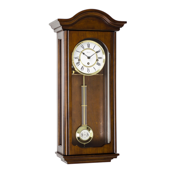 Antique Walnut wood wall clock with brass pendulum on a white background
