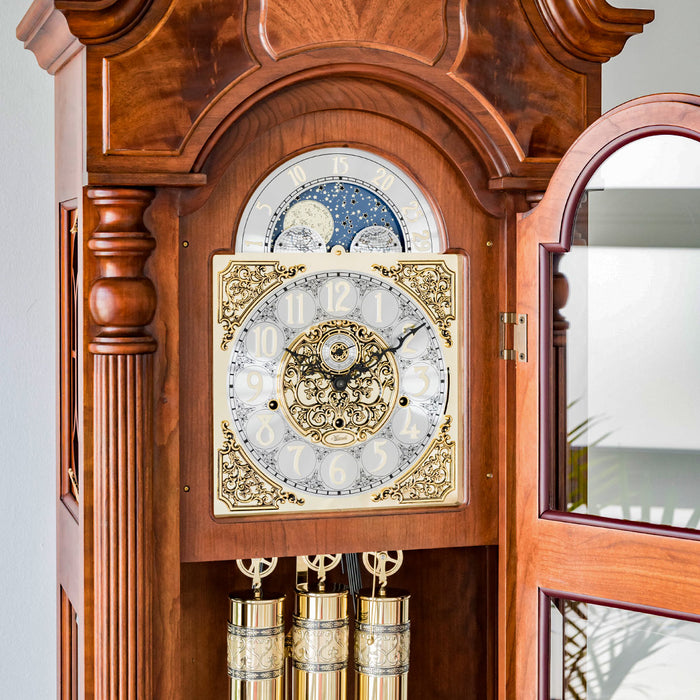 Close up of intricate wooden grandfather clock face made with highly detailed brass