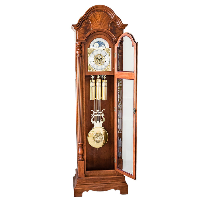 Wooden grandfather clock with brass highlights and open glass door on a white background