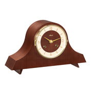 Walnut wood mantel clock with holes in the face for winding the mechanical movement inside 