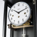 Close up of clock face with silver trim and Hermle logo