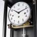 Close up of clock face with silver trim and Hermle logo