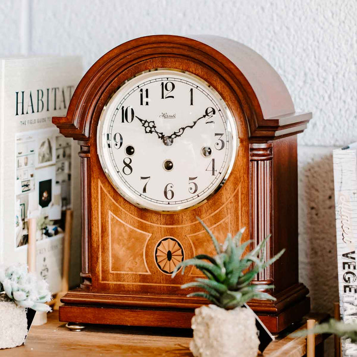 Clearbrook wooden mantel clock on table with books in front of white wall
