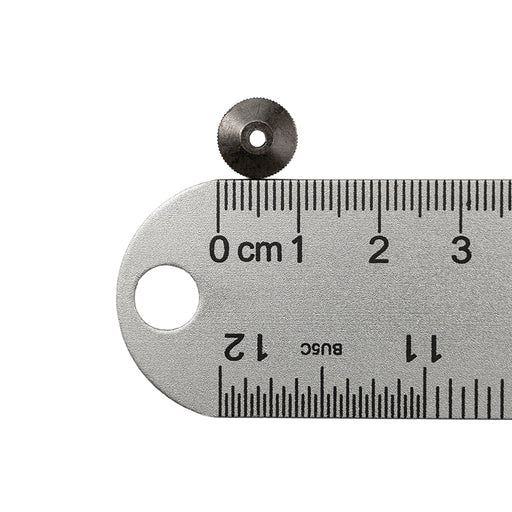 Black metal hand nut next to ruler showing 1 centimeter measurement.