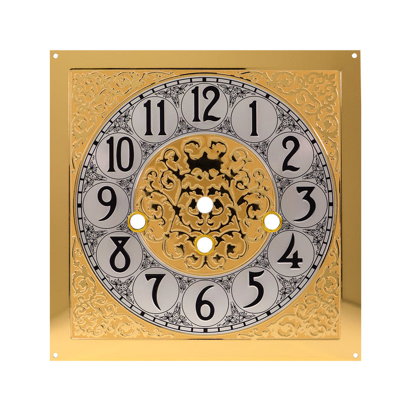Brass clock face with ornate design on white background.