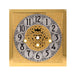 Brass clock face with ornate design on white background.
