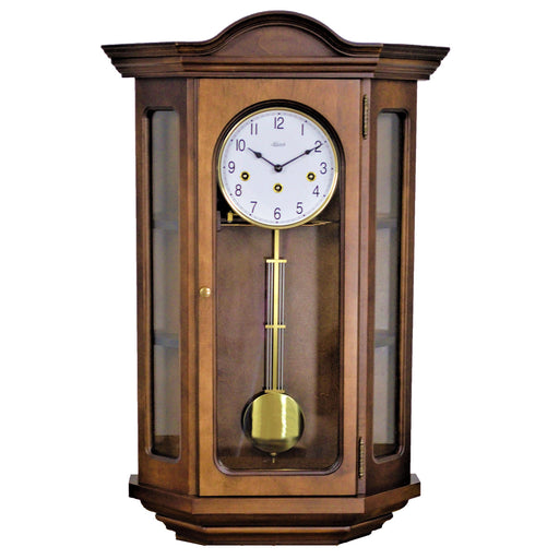 Decorative cherry wood clock with angled glass sides on a white background