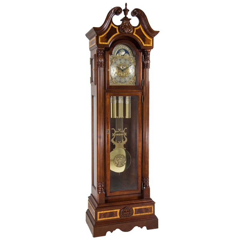Wooden grandfather clock with intricate design and brass face on a white background