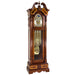 Wooden grandfather clock with intricate design, tubular chime movement and brass face on a white background