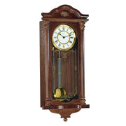 Intricate wooden wall clock with brass highlights on white background