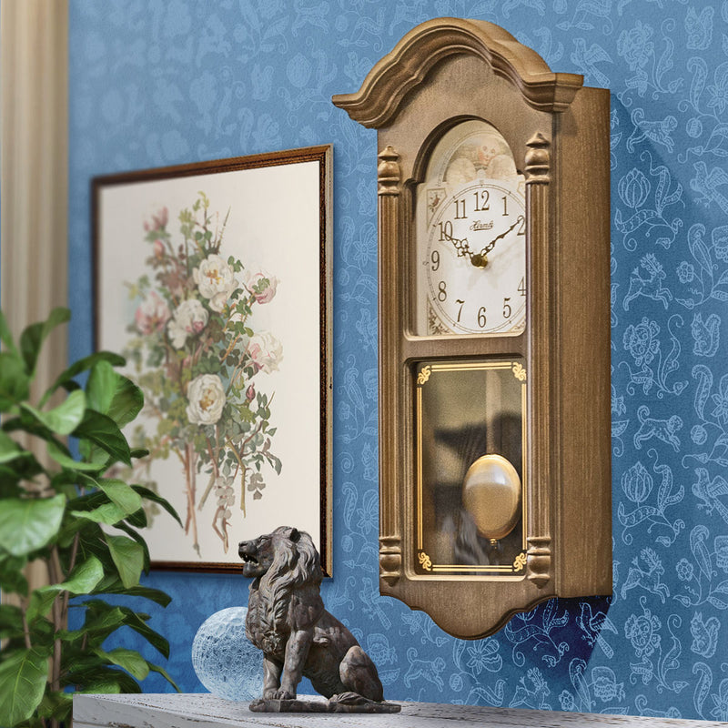 Wooden vintage style wall clock in farmhouse living room. 