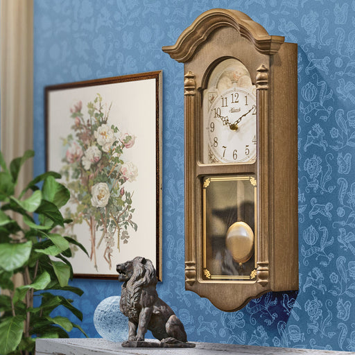 Wooden vintage style wall clock in farmhouse living room. 